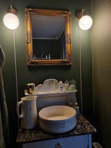 a bathroom with a toilet and a sink with two lights at Falsterly Glamping in Horbelöv
