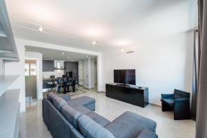 a living room with a couch and a kitchen at P&P Luxury Apartment in Bergamo