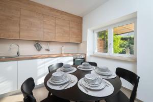 a kitchen with a table and chairs in a kitchen at House Leny by IstriaLux in Štokovci