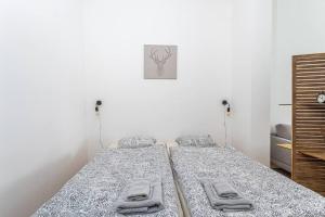 a bedroom with two beds with towels on them at Beautiful studio in Antwerp