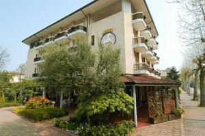 um grande edifício com um hotel numa rua em Al Cavallino Bianco em Lignano Sabbiadoro