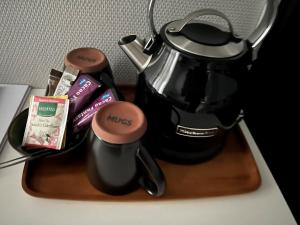 a tea pot sitting on a table with a tray at Hotel Frederikshavn in Frederikshavn
