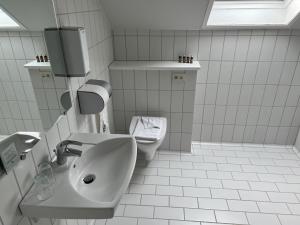 a bathroom with a sink and a toilet at Hotel Frederikshavn in Frederikshavn