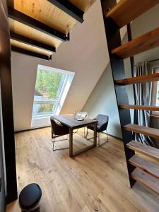 a dining room with a table and chairs and a window at Landgrafen-Mühle in Wallhalben