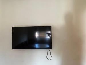 a flat screen tv hanging on a wall at Residence Ohod in Berrechid