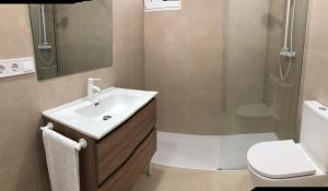 a bathroom with a sink and a shower and a toilet at 3 Bed Flat - Sleeps 5 - Wifi in Bellreguart