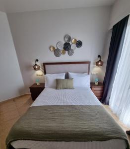 Postel nebo postele na pokoji v ubytování GreenHill Holiday Suites