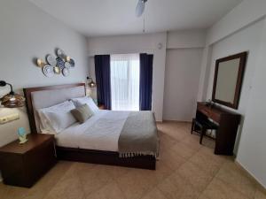 Postel nebo postele na pokoji v ubytování GreenHill Holiday Suites