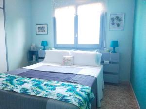 1 dormitorio azul con 1 cama grande y ventana en B&B El Solsonès - Olius, en El Pi de Sant Just
