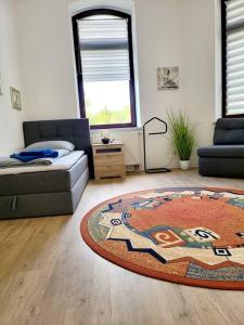 a living room with a couch and a rug at Ferienwohnung WESTEND in Plauen