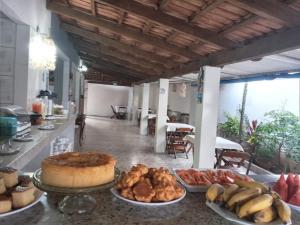 a table with many different types of food on it at Pousada Flor Dos Ipês in Trindade