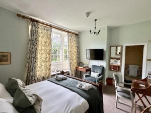 a bedroom with a bed and a desk and a chair at Montigo Resorts, Somerset in Shepton Mallet