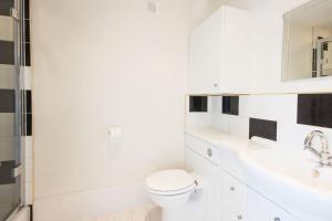 a white bathroom with a toilet and a sink at Windrush Lake 88, Waterside in South Cerney +22 photos