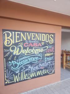 a chalkboard sign on the side of a building at Pachá Hostel Backpack in Salta