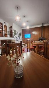 a dining room with a table with a vase on it at Pachá Hostel Backpack in Salta