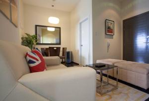 a living room with a couch and a table at One BR Penthouse Unit-Knightsbridge Residences in Manila