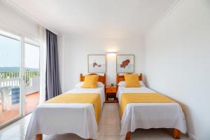 Postel nebo postele na pokoji v ubytování Hotel Apartamentos Vibra Monterrey
