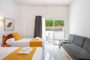 Postel nebo postele na pokoji v ubytování Hotel Apartamentos Vibra Monterrey