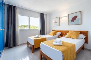 Postel nebo postele na pokoji v ubytování Hotel Apartamentos Vibra Monterrey