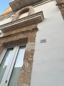 a building with a sign on the side of it at L’Edicola Votiva in Casarano