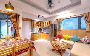a living room with a couch and a kitchen at Taian Hotel & Apartment in Da Nang