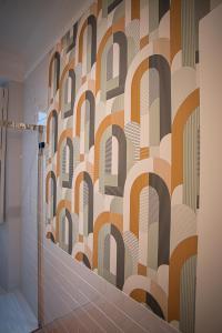 a bathroom with a patterned wall at Setubal History - By Y Concept in Setúbal