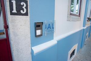 a room with a blue wall with the number thirteen at Setubal History - By Y Concept in Setúbal