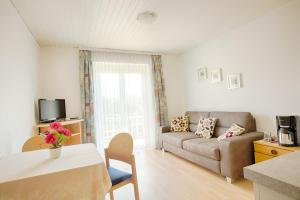 a living room with a couch and a table at Haus Kaiser in Schiefling am See