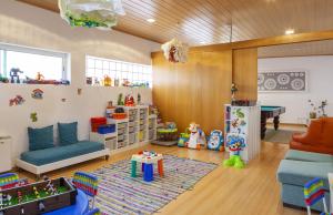 a childrens room with a couch and a table at Boutique Hotel Casa do Outeiro - Arts & Crafts in Batalha