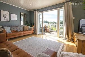 a living room with a couch and a television at Windrush Lake 87, The Retreat - P in South Cerney
