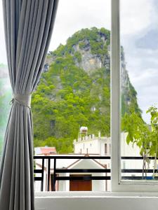 a window with a view of a mountain at Hideaway Homestay in Phong Nha