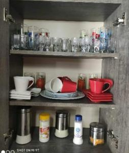 a shelf with dishes and cups and other items on it at Didveli residenc in Bakuriani