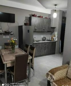 a kitchen with a table and chairs and a kitchen with a table and a kitchen at Didveli residenc in Bakuriani