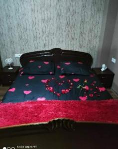 a bedroom with a bed with pink flowers on it at Didveli residenc in Bakuriani