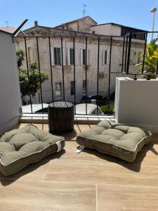 dwie poduszki siedzące na podłodze pokoju z oknem w obiekcie Sunset 221 Cagliari w Cagliari