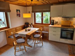 a kitchen with a table and chairs in a room at Ferienhaus Vakanz in Raggal