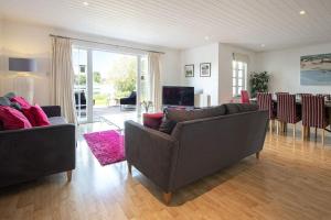 a living room with two couches and a dining room at Windrush Lake 89, Lodge View - P in South Cerney