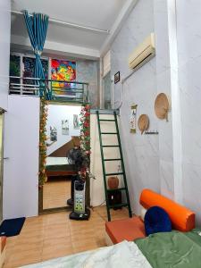 a room with a bunk bed and a ladder at H2Homestay phố cổ check in tự động in Hanoi