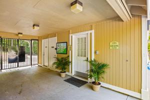 a hallway of a house with two potted plants at Ship Dock Lane B in Osage Beach