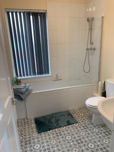 a bathroom with a tub and a toilet and a sink at Waterloo Sunset in Blackpool +16 photos