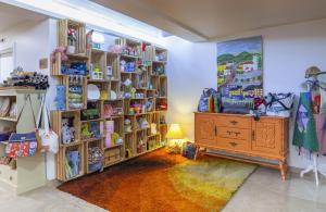 a room with wooden shelves and a dresser in it at Boutique Hotel Casa do Outeiro - Arts & Crafts in Batalha