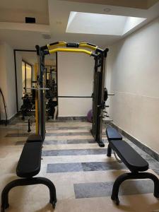 a gym with two benches in a room at New apartment with pool near the sea in Akbük