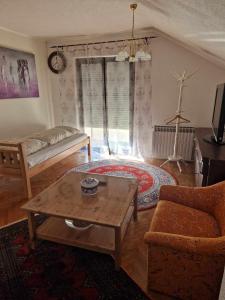 a living room with a couch and a coffee table at Apartment Kula in Gračanica