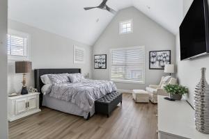 a white bedroom with a bed and a chair at Lake Home Retreat w/Lake/Marina Access Golf Cart in Winchester