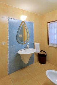 y baño con lavabo y espejo. en Villa Les Tortues, en Cattolica