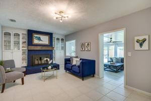 a living room with a blue couch and a fireplace at Ponte Vedra Beach Vacation Rental with Private Pool! in Ponte Vedra Beach