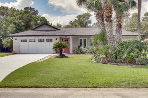 a house with a palm tree and a garage at Ponte Vedra Beach Vacation Rental with Private Pool! in Ponte Vedra Beach