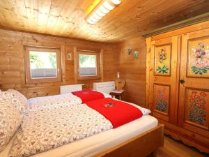 a bedroom with a bed in a wooden cabin at Tröger I in Bruck am Ziller