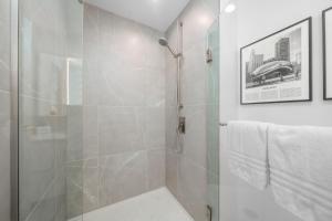 a bathroom with a shower with a glass door at Level Chicago - Fulton Market in Chicago