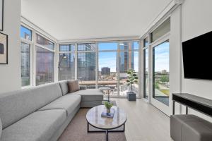 a living room with a couch and a tv at Level Chicago - Fulton Market in Chicago